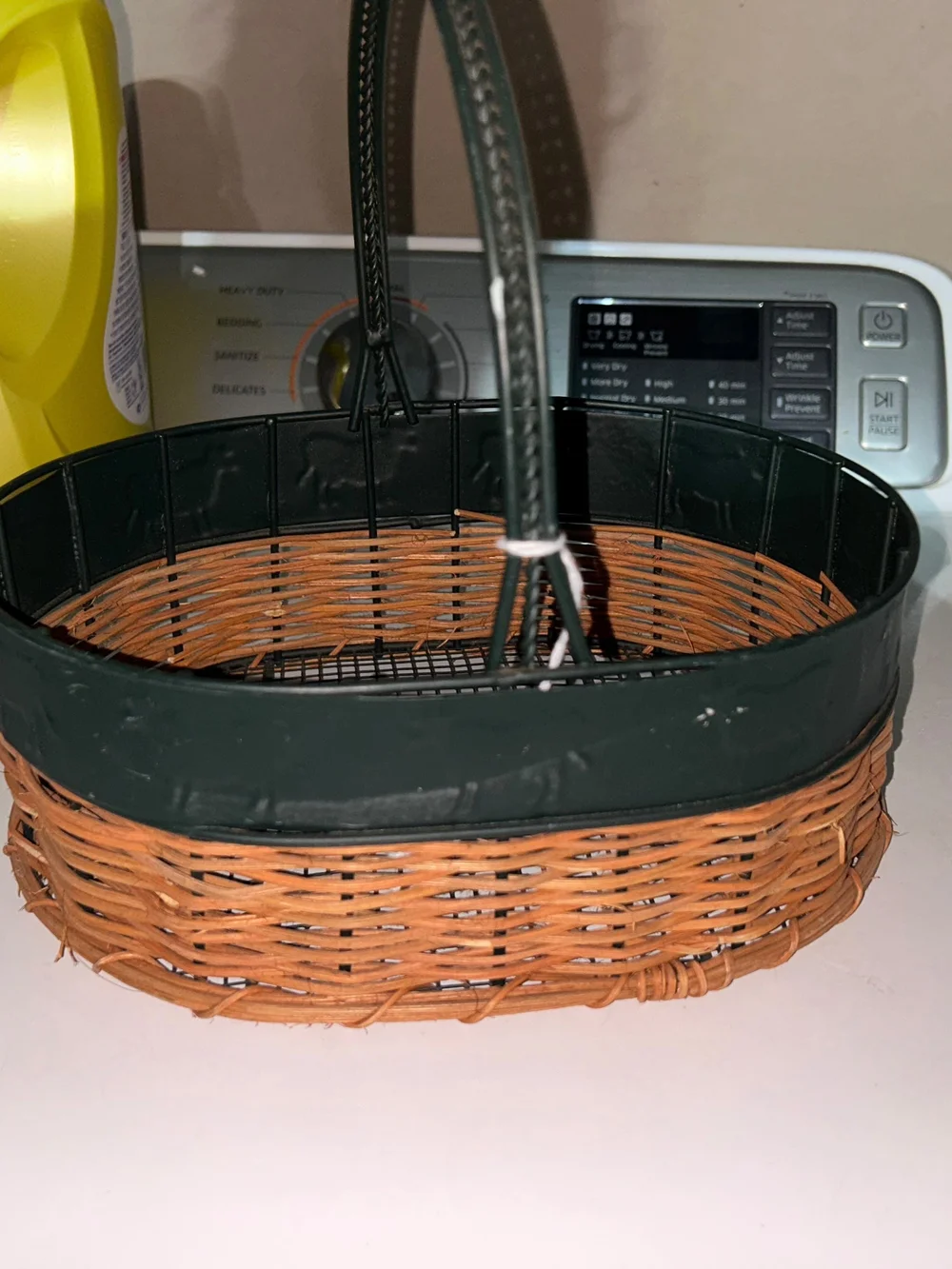 vintage oval gathering basket with a dark green metal frame.